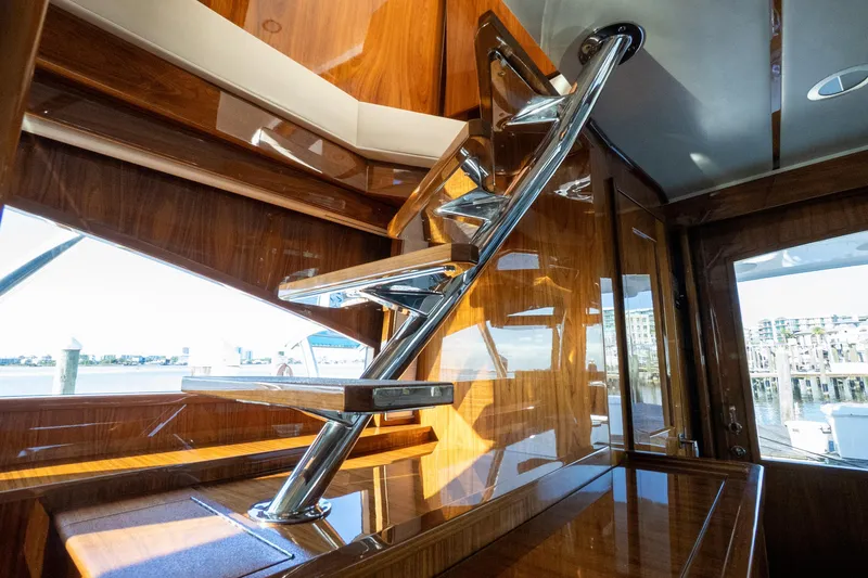 Galati Yacht Sales Trade Yacht Photos Pics Luxurious interior staircase of 2021 Viking 72 Enclosed Bridge yacht with wooden finish.