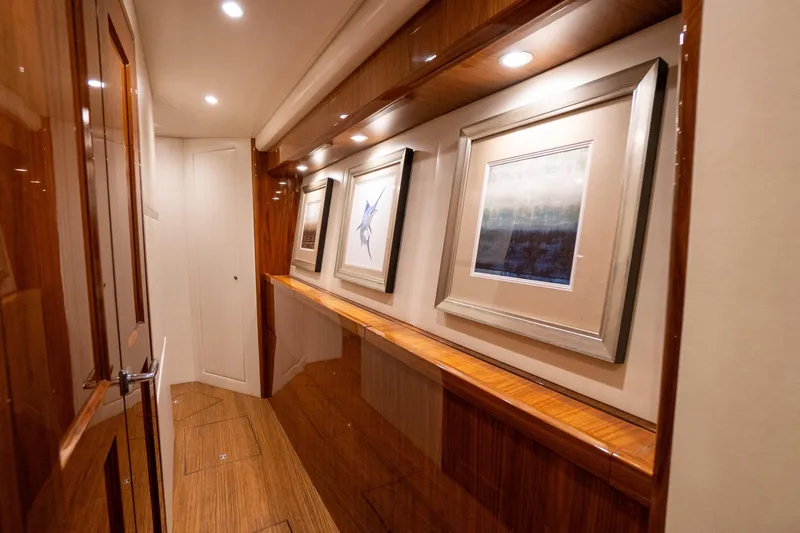 Galati Yacht Sales Trade Yacht Photos Pics Luxurious hallway in 2021 Viking 72 Enclosed Bridge yacht with framed artwork.