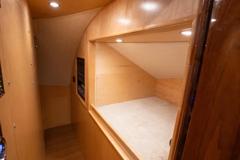 Galati Yacht Sales Trade Yacht Photos Pics Interior of 2021 Viking 72 Enclosed Bridge yacht, featuring wood paneling and cozy carpeted space.