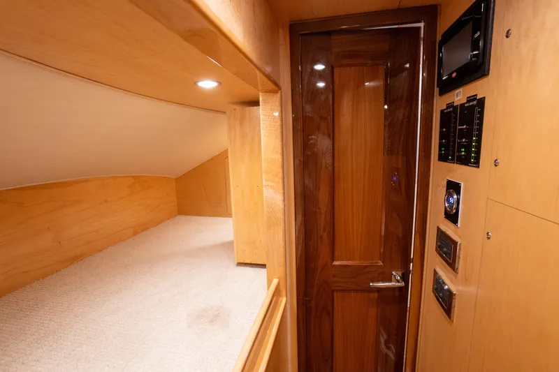 Galati Yacht Sales Trade Yacht Photos Pics Interior of 2021 Viking 72 Enclosed Bridge yacht with wood paneling and control panels.