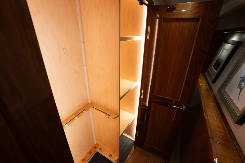 Galati Yacht Sales Trade Yacht Photos Pics Luxurious wooden closet interior on a 2021 Viking 72 Enclosed Bridge yacht.