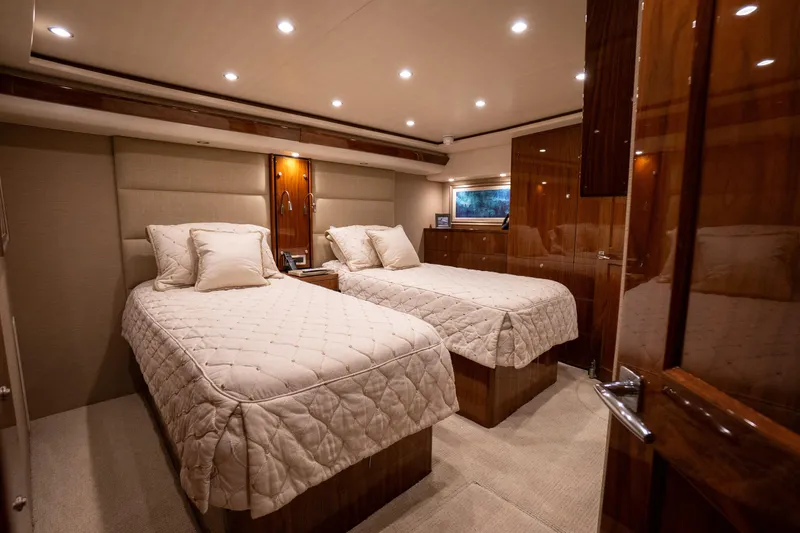 Galati Yacht Sales Trade Yacht Photos Pics Luxurious cabin interior of 2021 Viking 72 Enclosed Bridge yacht with twin beds.