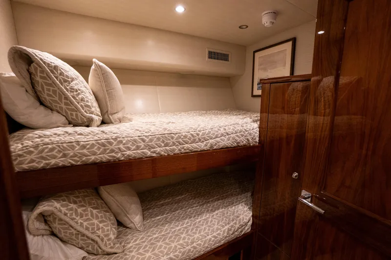 Galati Yacht Sales Trade Yacht Photos Pics Luxurious cabin with bunk beds in 2021 Viking 72 Enclosed Bridge yacht.