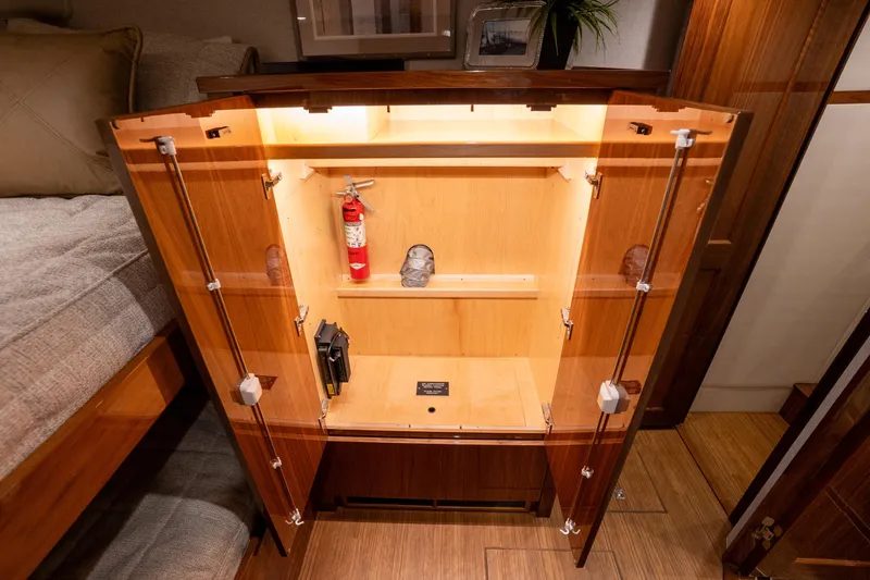 Galati Yacht Sales Trade Yacht Photos Pics Open cabinet with fire extinguisher inside Viking 72 Enclosed Bridge yacht, 2021 model.