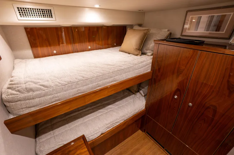 Galati Yacht Sales Trade Yacht Photos Pics Luxurious cabin interior of 2021 Viking 72 Enclosed Bridge yacht with wooden finishes.