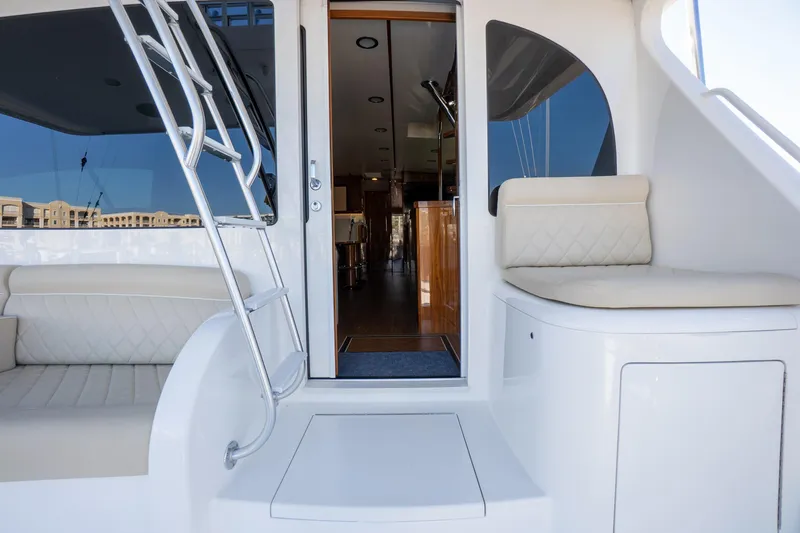 Galati Yacht Sales Trade Yacht Photos Pics 2021 Viking 72 Enclosed Bridge yacht interior with seating and ladder.