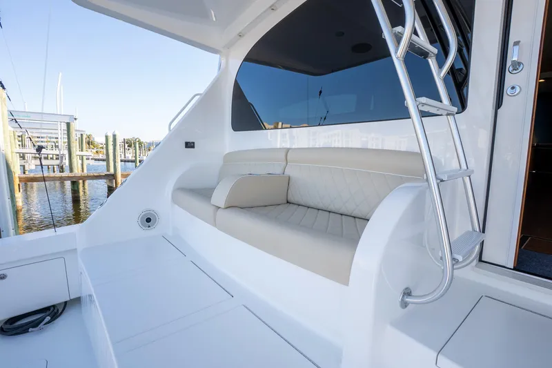 Galati Yacht Sales Trade Yacht Photos Pics 2021 Viking 72 Enclosed Bridge yacht with sleek seating and ladder, docked at marina.