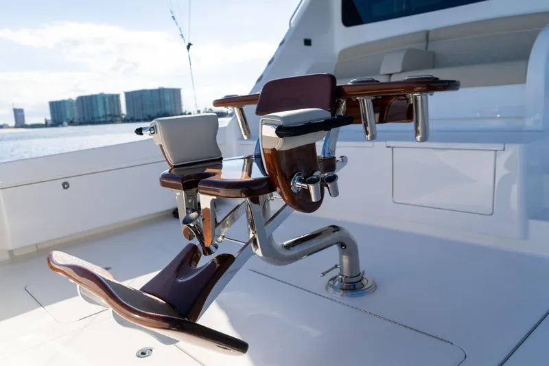 Galati Yacht Sales Trade Yacht Photos Pics Luxurious 2021 Viking 72 Enclosed Bridge yacht with polished fishing chair on deck.