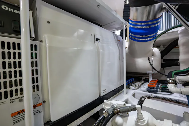 Galati Yacht Sales Trade Yacht Photos Pics Engine room of 2021 Viking 72 Enclosed Bridge yacht with Onan generator and piping.