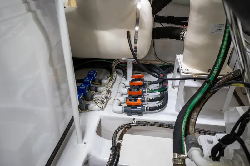 Galati Yacht Sales Trade Yacht Photos Pics Engine room of 2021 Viking 72 Enclosed Bridge yacht, showcasing intricate wiring and components.