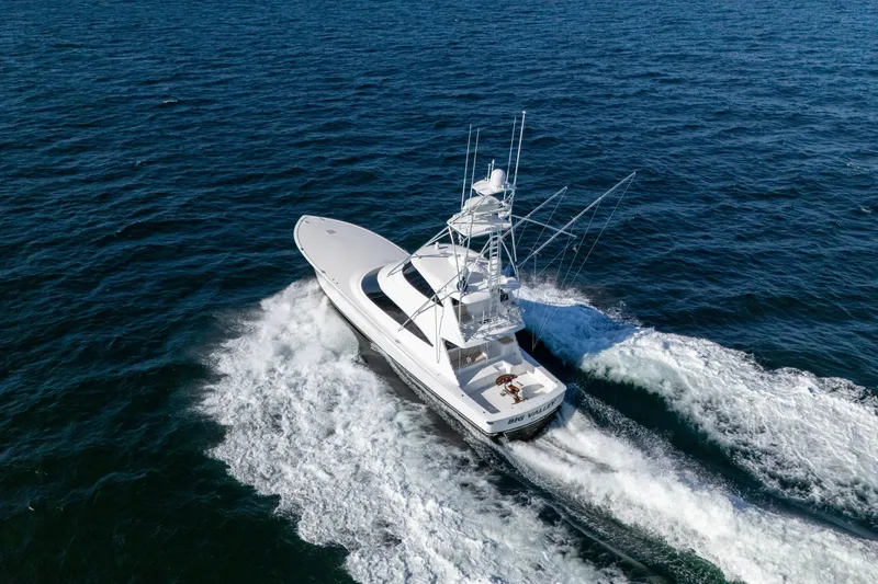 Galati Yacht Sales Trade Yacht Photos Pics 2021 Viking 72 Enclosed Bridge yacht cruising on open ocean waters.