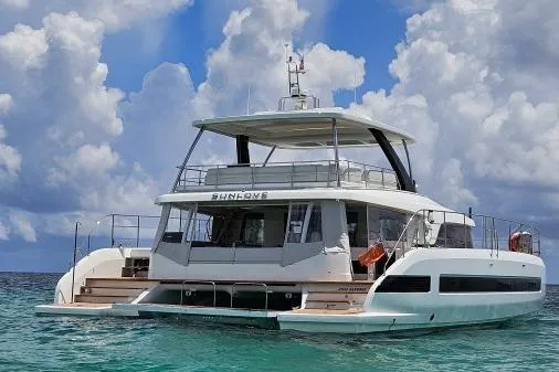 Sunlove Yacht Photos Pics 2024 Lagoon SIXTY 7 yacht on clear water under a cloudy sky.