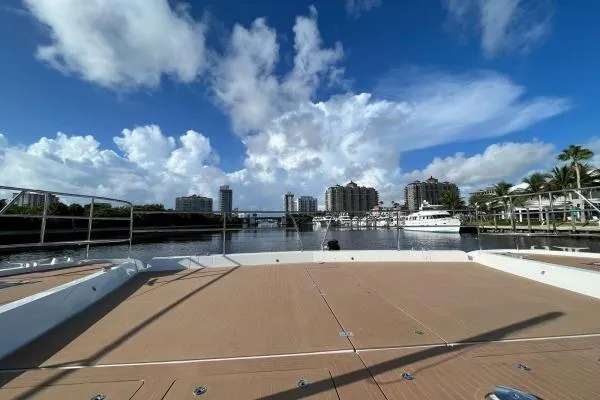 Sunlove Yacht Photos Pics 2024 Lagoon SIXTY 7 yacht deck with city skyline and blue sky backdrop.