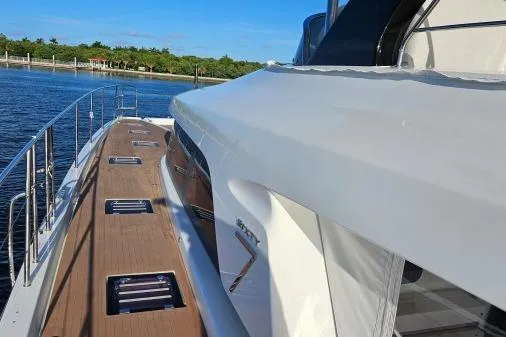 Sunlove Yacht Photos Pics 2024 Lagoon SIXTY 7 yacht, sleek design, wooden deck, docked by calm waters.