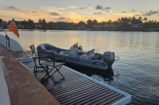Sunlove Yacht Photos Pics 2024 Lagoon SIXTY 7 yacht with tender at sunset, serene waterfront view.