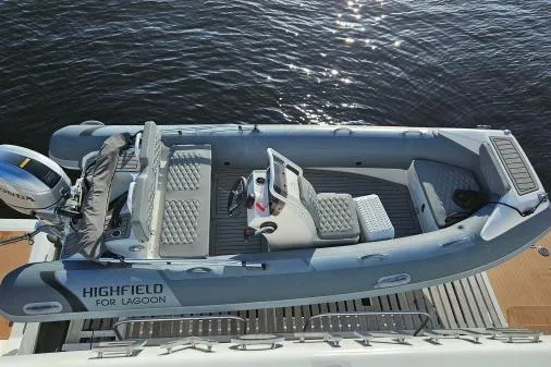 Sunlove Yacht Photos Pics 2024 Lagoon SIXTY 7 boat with Highfield tender, docked on calm water.