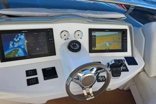 Sunlove Yacht Photos Pics 2024 Lagoon SIXTY 7 yacht helm with navigation screens and controls.