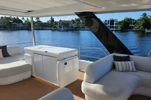 Sunlove Yacht Photos Pics Luxurious 2024 Lagoon SIXTY 7 yacht interior with plush seating and scenic waterfront view.