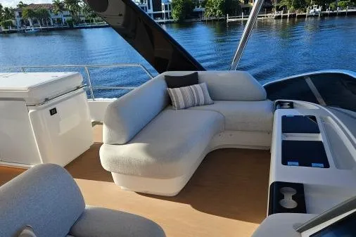 Sunlove Yacht Photos Pics Luxurious 2024 Lagoon SIXTY 7 yacht deck with plush seating and scenic waterfront view.