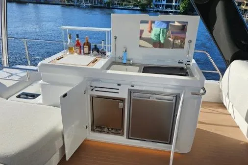 Sunlove Yacht Photos Pics Outdoor kitchen on 2024 Lagoon SIXTY 7 yacht with bar and appliances by the water.