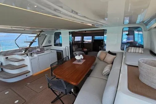 Sunlove Yacht Photos Pics Luxurious interior of 2024 Lagoon SIXTY 7 yacht with elegant seating and dining area.