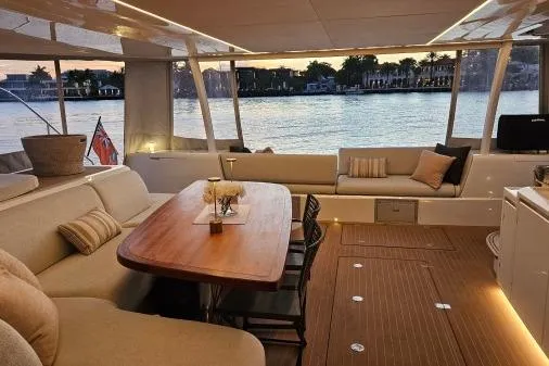 Sunlove Yacht Photos Pics Luxurious 2024 Lagoon SIXTY 7 yacht interior with elegant seating and sunset view.