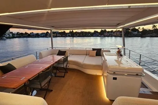 Sunlove Yacht Photos Pics Luxurious 2024 Lagoon SIXTY 7 yacht interior with elegant seating and dining area at sunset.