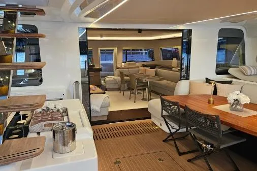 Sunlove Yacht Photos Pics Luxurious interior of 2024 Lagoon SIXTY 7 yacht with elegant dining and seating areas.