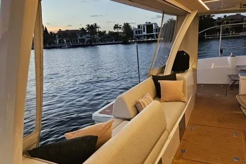 Sunlove Yacht Photos Pics 2024 Lagoon SIXTY 7 yacht interior with waterfront view at sunset.