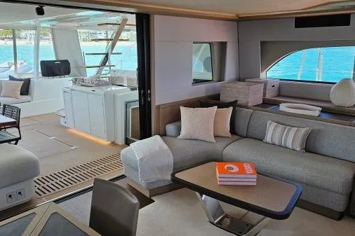 Sunlove Yacht Photos Pics Luxurious interior of 2024 Lagoon SIXTY 7 yacht with modern furnishings and ocean view.