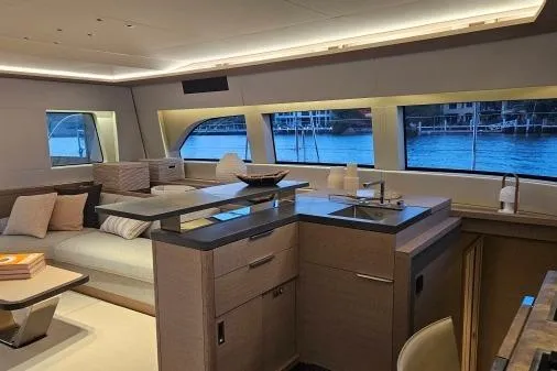 Sunlove Yacht Photos Pics Luxurious interior of 2024 Lagoon SIXTY 7 yacht with modern kitchen and waterfront view.