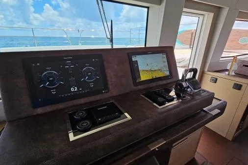Sunlove Yacht Photos Pics 2024 Lagoon SIXTY 7 yacht helm with navigation screens and ocean view.