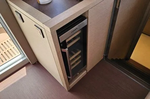 Sunlove Yacht Photos Pics 2024 Lagoon SIXTY 7 yacht interior with built-in wine cooler and modern cabinetry.