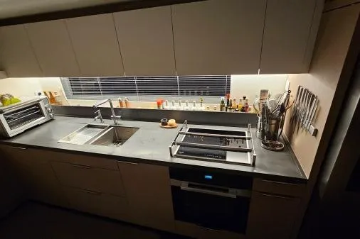 Sunlove Yacht Photos Pics Modern kitchen in 2024 Lagoon SIXTY 7 yacht with sleek countertops and appliances.