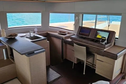 Sunlove Yacht Photos Pics Interior of 2024 Lagoon SIXTY 7 yacht with modern navigation equipment and ocean view.