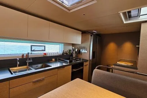 Sunlove Yacht Photos Pics Modern kitchen interior of 2024 Lagoon SIXTY 7 yacht with sleek design and ample lighting.