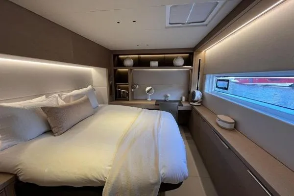 Sunlove Yacht Photos Pics Luxurious bedroom interior of 2024 Lagoon SIXTY 7 yacht with modern design and ambient lighting.