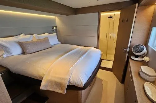 Sunlove Yacht Photos Pics Luxurious bedroom interior of 2024 Lagoon SIXTY 7 yacht with ensuite bathroom.