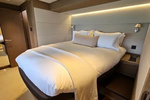 Sunlove Yacht Photos Pics Luxurious bedroom interior of 2024 Lagoon SIXTY 7 yacht with elegant bedding and modern design.
