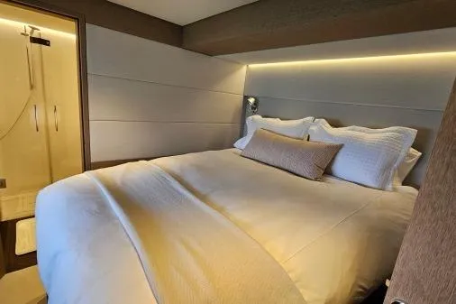 Sunlove Yacht Photos Pics Luxurious bedroom interior of 2024 Lagoon SIXTY 7 yacht with modern design and ambient lighting.