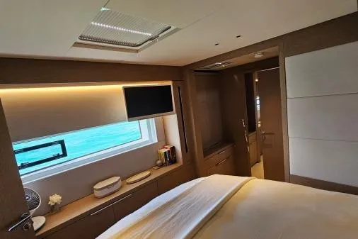 Sunlove Yacht Photos Pics Luxurious bedroom interior of 2024 Lagoon SIXTY 7 yacht with ocean view.
