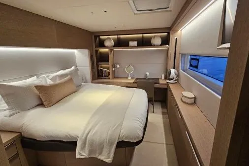 Sunlove Yacht Photos Pics Luxurious bedroom interior of 2024 Lagoon SIXTY 7 yacht with modern design and cozy ambiance.