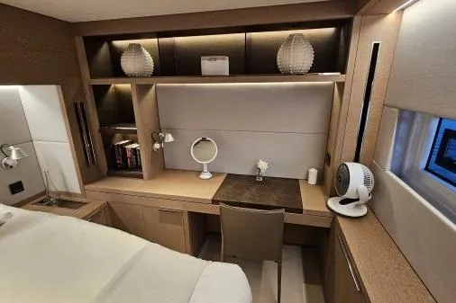 Sunlove Yacht Photos Pics Luxurious interior of 2024 Lagoon SIXTY 7 yacht with elegant desk and shelving.