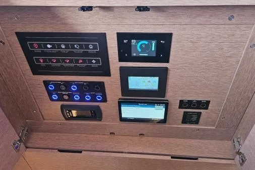 Sunlove Yacht Photos Pics Control panel of 2024 Lagoon SIXTY 7 yacht with digital displays and switches.