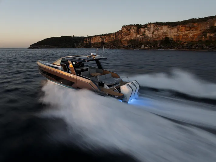  Yacht Photos Pics Schaefer V44 Yacht 2024 speeding along rocky coastline.