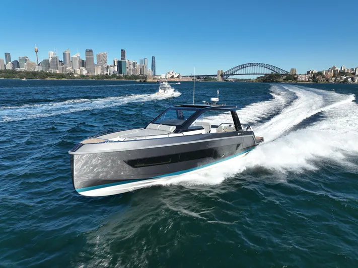  Yacht Photos Pics Schaefer V44 2024 yacht cruising on water with city skyline.