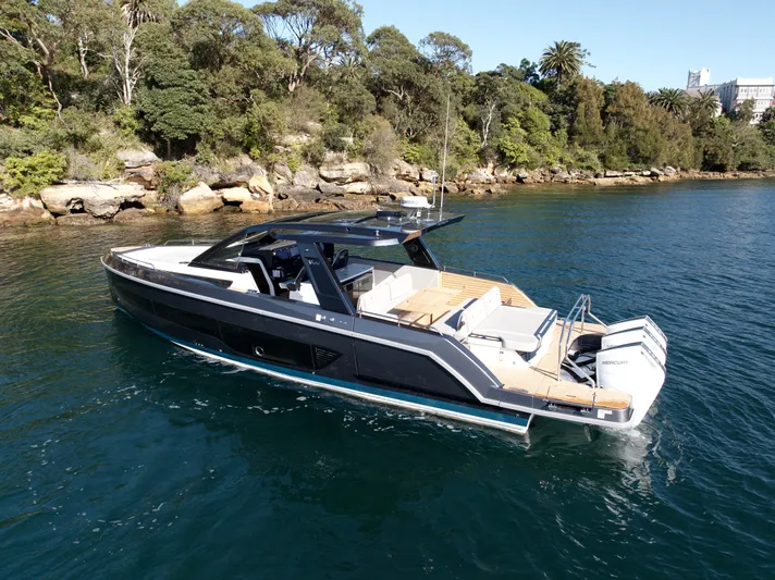  Yacht Photos Pics Luxury Schaefer V44 2024 yacht on calm water near wooded shoreline.