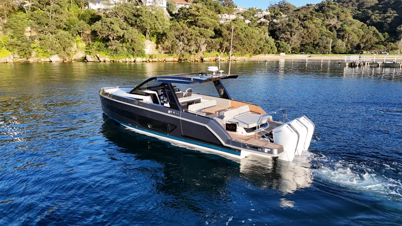  Yacht Photos Pics Schaefer V44 2024 yacht on calm water, surrounded by lush greenery.