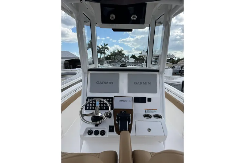  Yacht Photos Pics 2025 Caymas 291 boat dashboard with Garmin navigation system and Mercury controls.