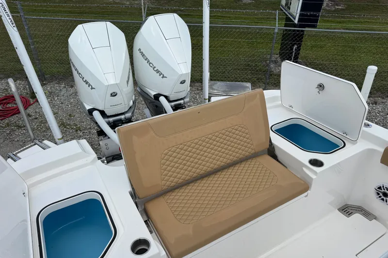  Yacht Photos Pics 2025 Caymas 291 boat with dual Mercury engines, tan seating, and storage compartments.